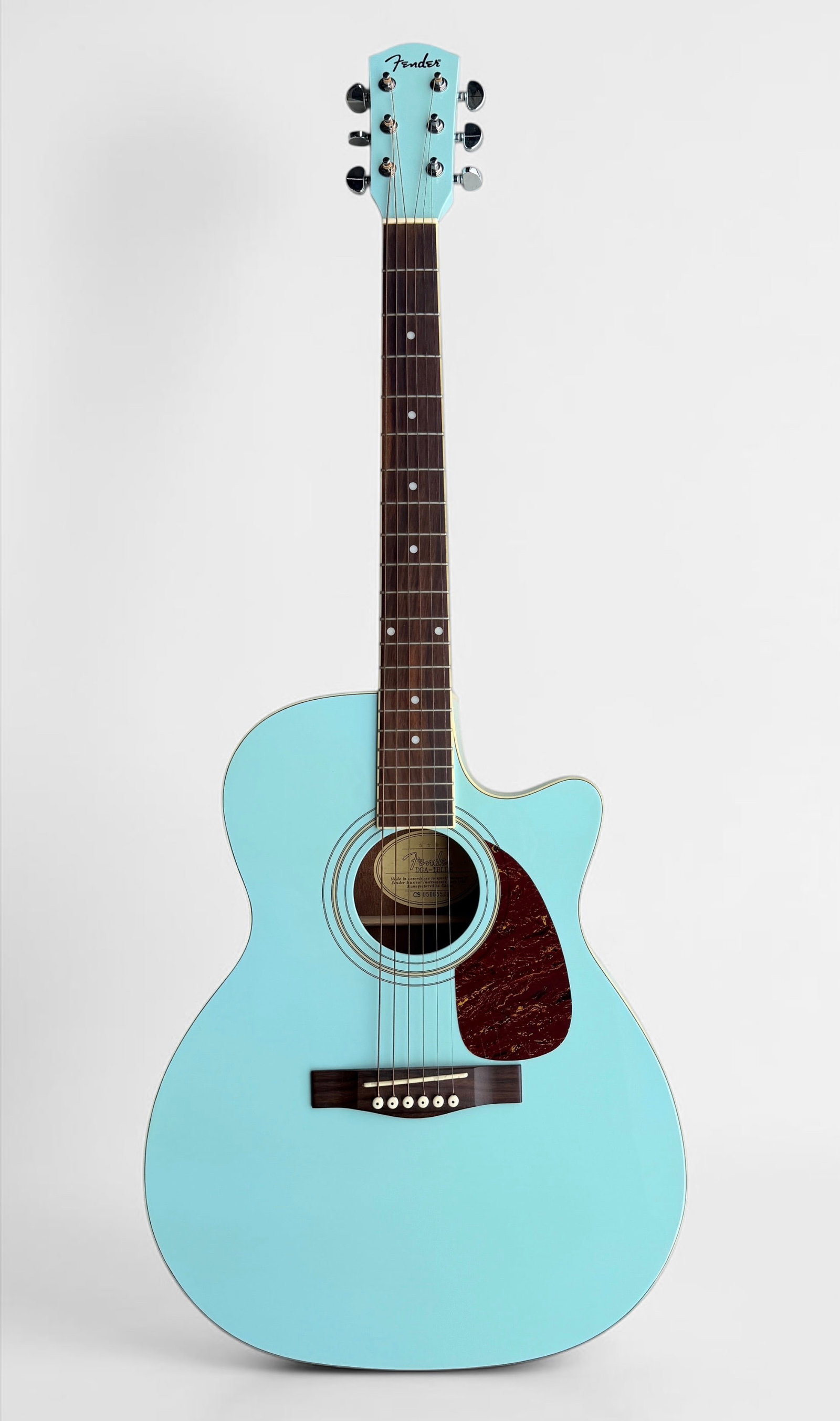 Fender DGA-1Blue Daphne Blue Acoustic Guitar: The guitar comes in a soft gig bag. Serial Number: CS05065521 Length: 41" Condition: Light scratches to the body. Scratches to the tortoise shell pick guard, consistent 