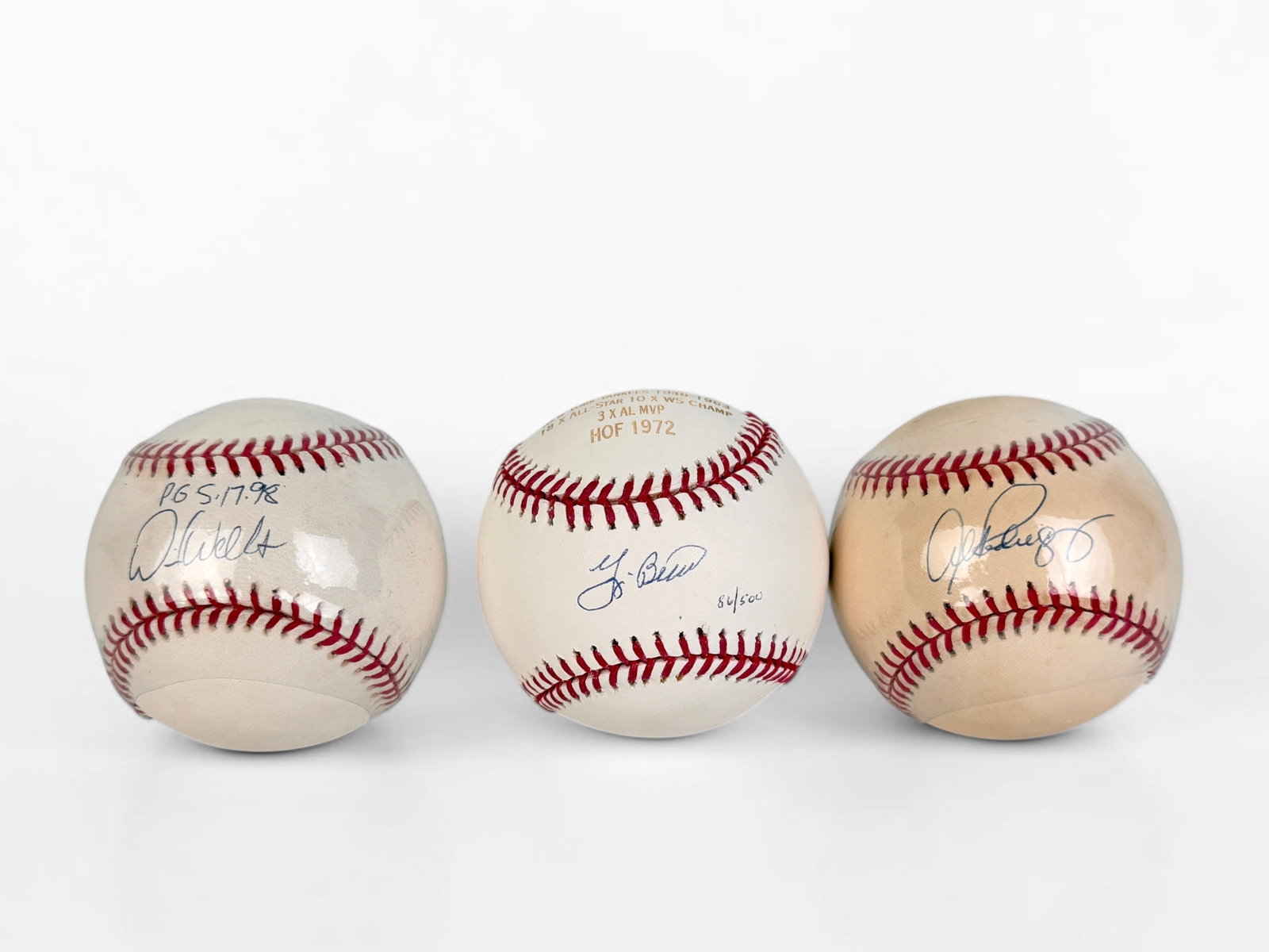 (3) Signed NY Yankees Baseballs Inc Yogi Berra (F): Signed by Alex Rodriguez, David Wells, and Yogi Berra. Two of the balls comes in their own display cases. Dimensions: Approx. 3" Diameter Condition: Various levels of ag