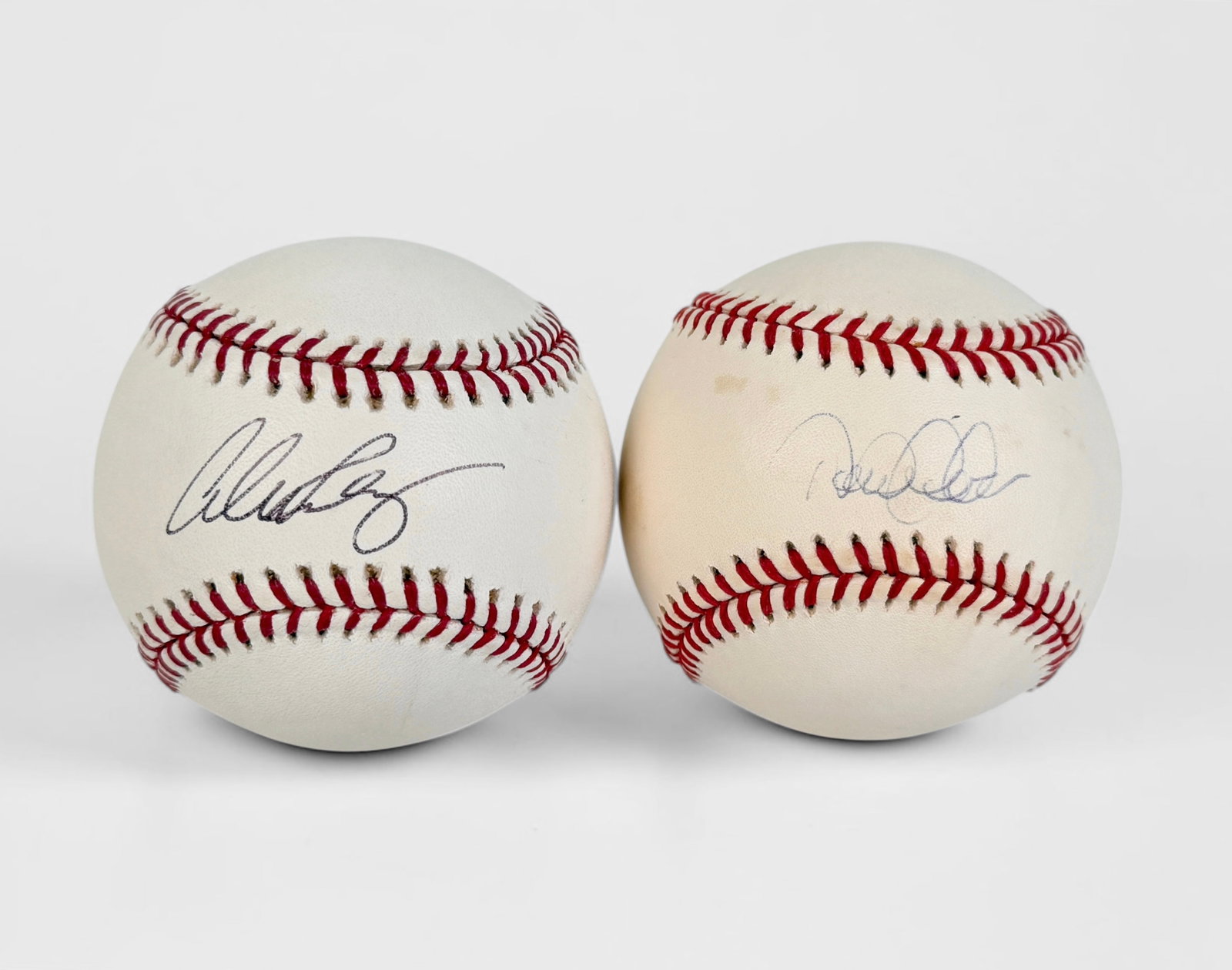 (2) Signed Derek Jeter & Alex Rodriguez Baseballs (A): Signed by Derek Jeter and Alex Rodriguez The balls come in display cases. Dimensions: Approx. 3" Diameter Condition: Minor wear to the baseballs, but they are in