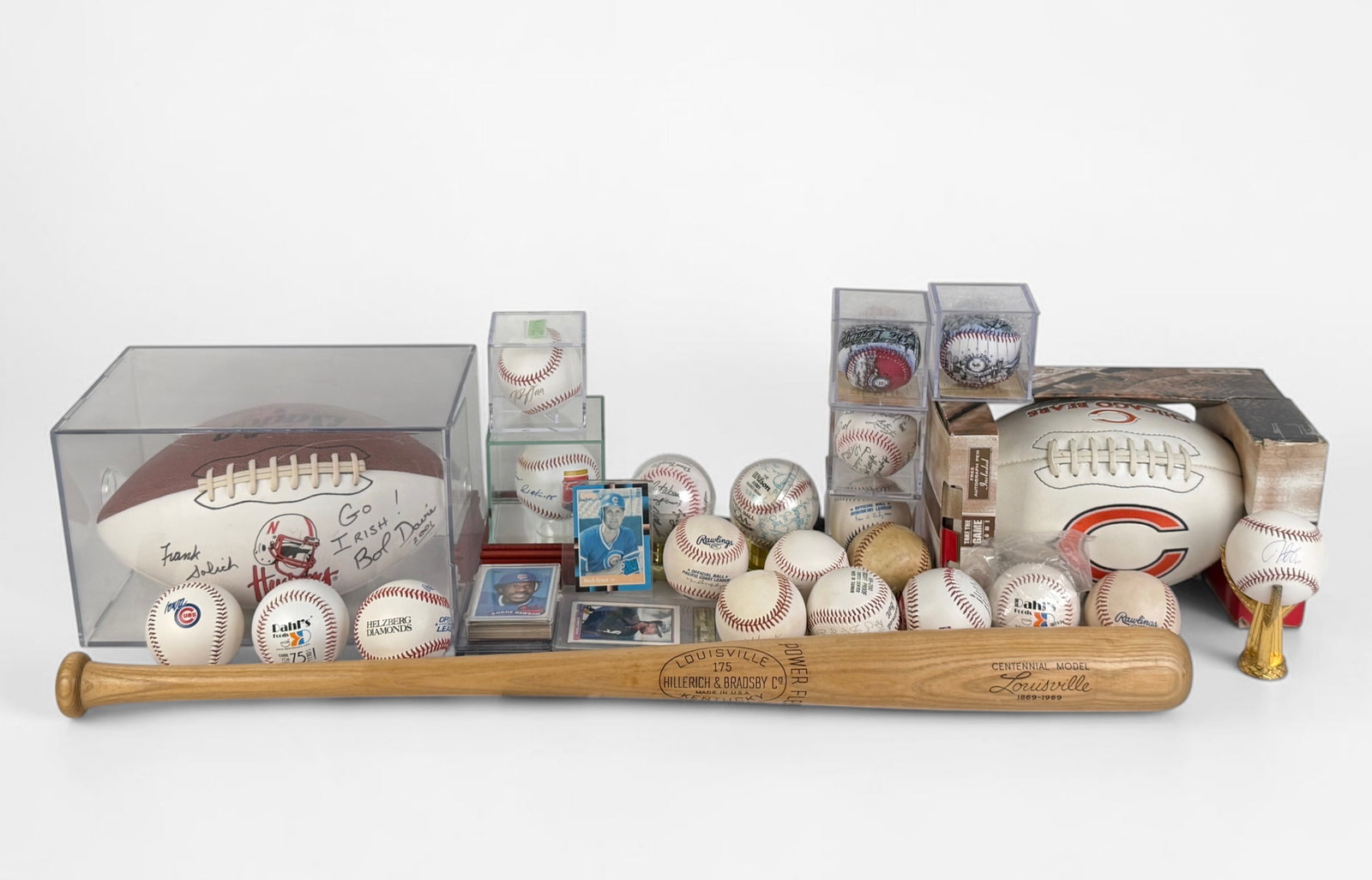 Large Group of Misc. Sports Memorabilia: Lot includes footballs, baseball bat, several baseballs, and trading cards. Condition: Items are in various levels of aging. Some items have signatures. Please see images for