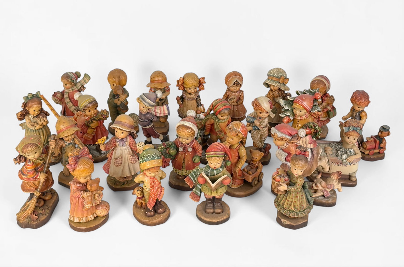 (25) Anri Ferrandiz Figures Wooden Carvings: An arrangement of figures from the Anri Ferrandiz collection. All are marked on the bottom. Dimensions: Approx. 6 1/2" Tall Condition: Overall, the collection is in good