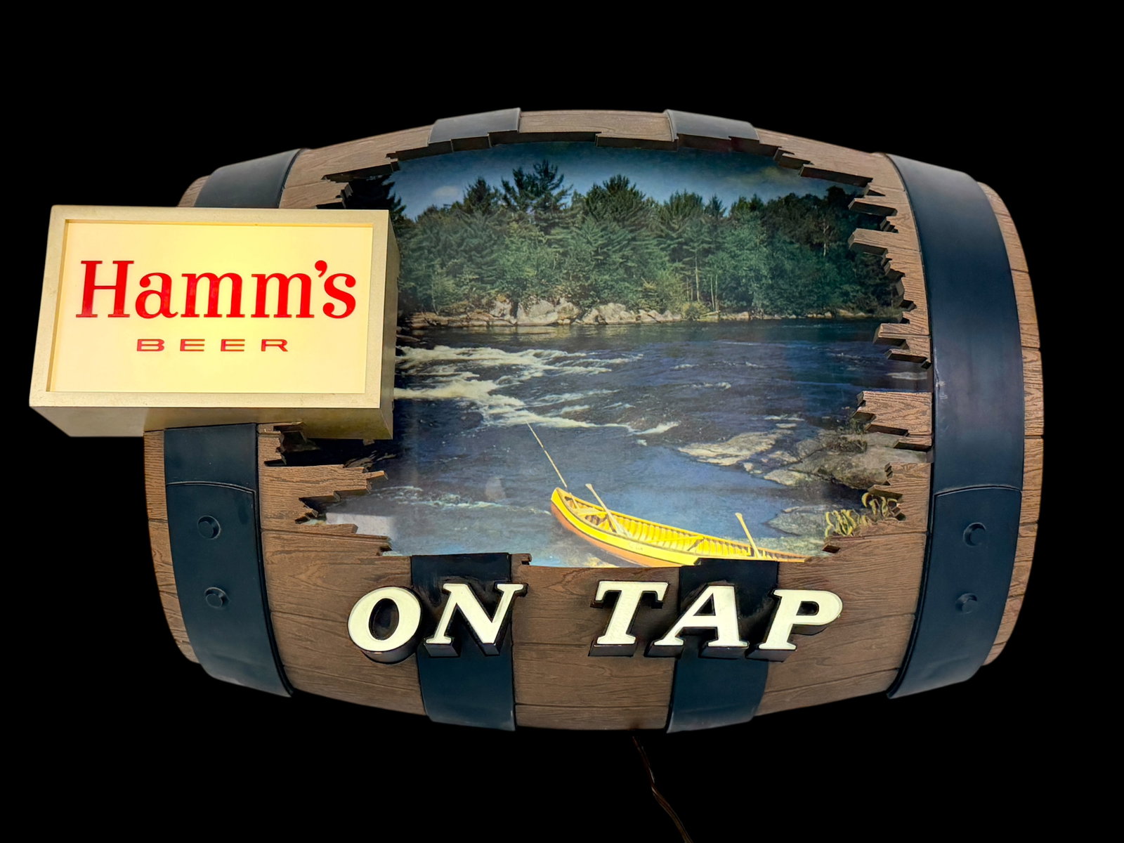 "Hamm's Beer" Barrel Sign: Dimensions: 15" T x 21" W x 8" D Condition: The sign lights up when plugged in. There is light wear to the exterior, otherwise the sign is in good condition. The wiring should