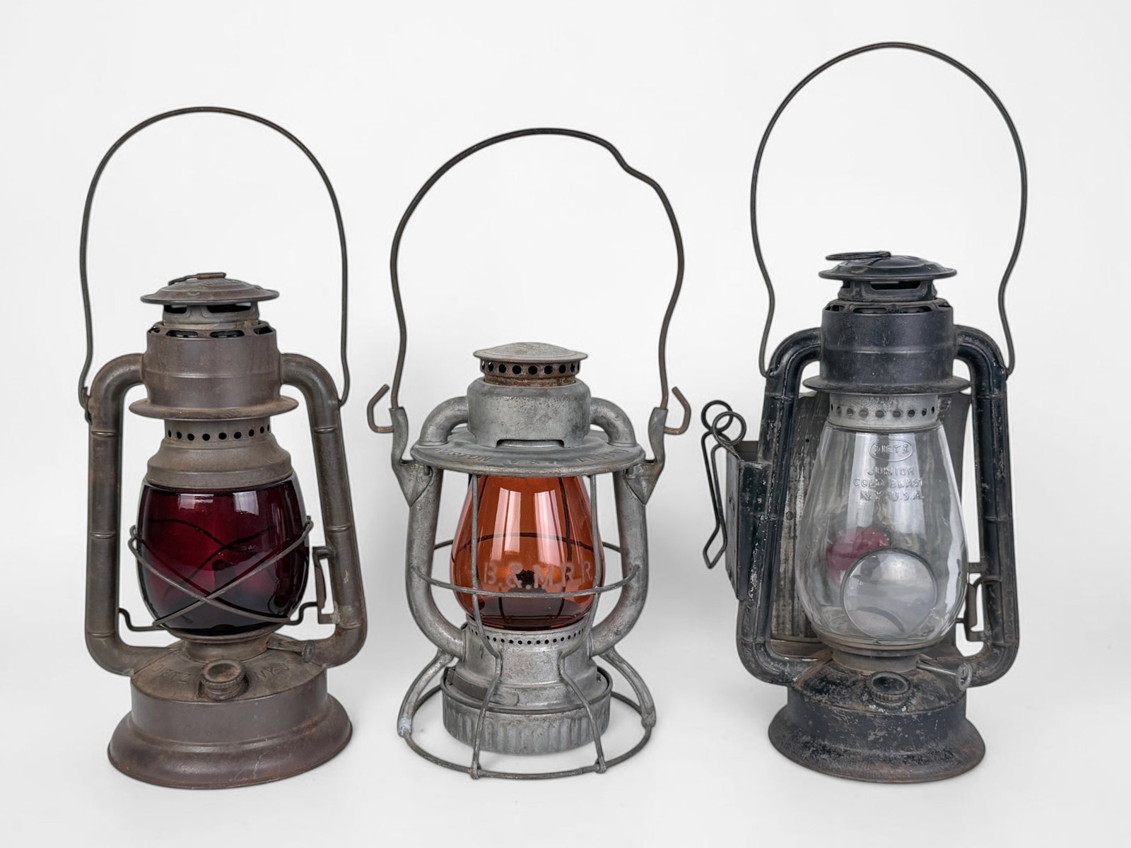 (3) Dietz Antique Oil Lanterns: Dimensions of Tallest Lantern: 17" Tall x 5 1/2" Widest Point (Including Handle) Condition: The lamps need new wicks to be functional. Rust throughout all lanterns, consistent with