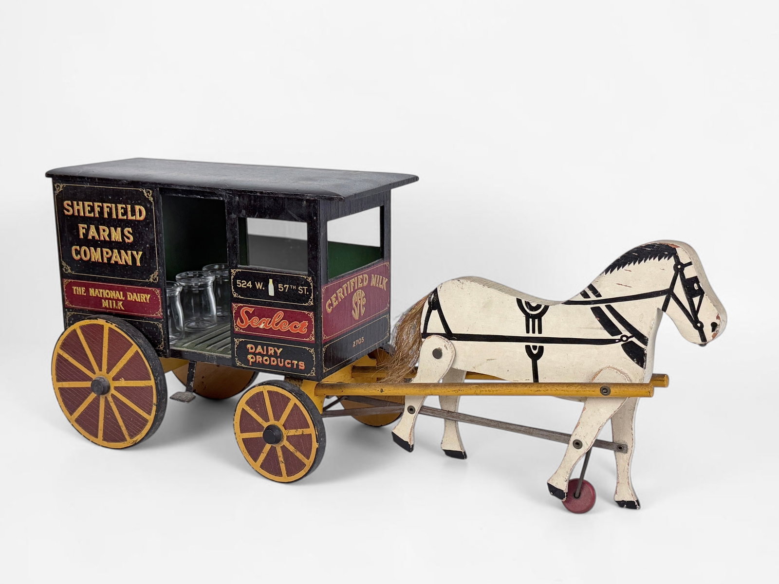 Vintage Sheffield Farms Co. Wooden Dairy Toy Wagon: Dimensions: 9 1/2" Tall x 22" Wide Condition: Minor loss to pigment throughout. The wood has some scratches and marks to it, but is in overall good condition. The mechanics to m