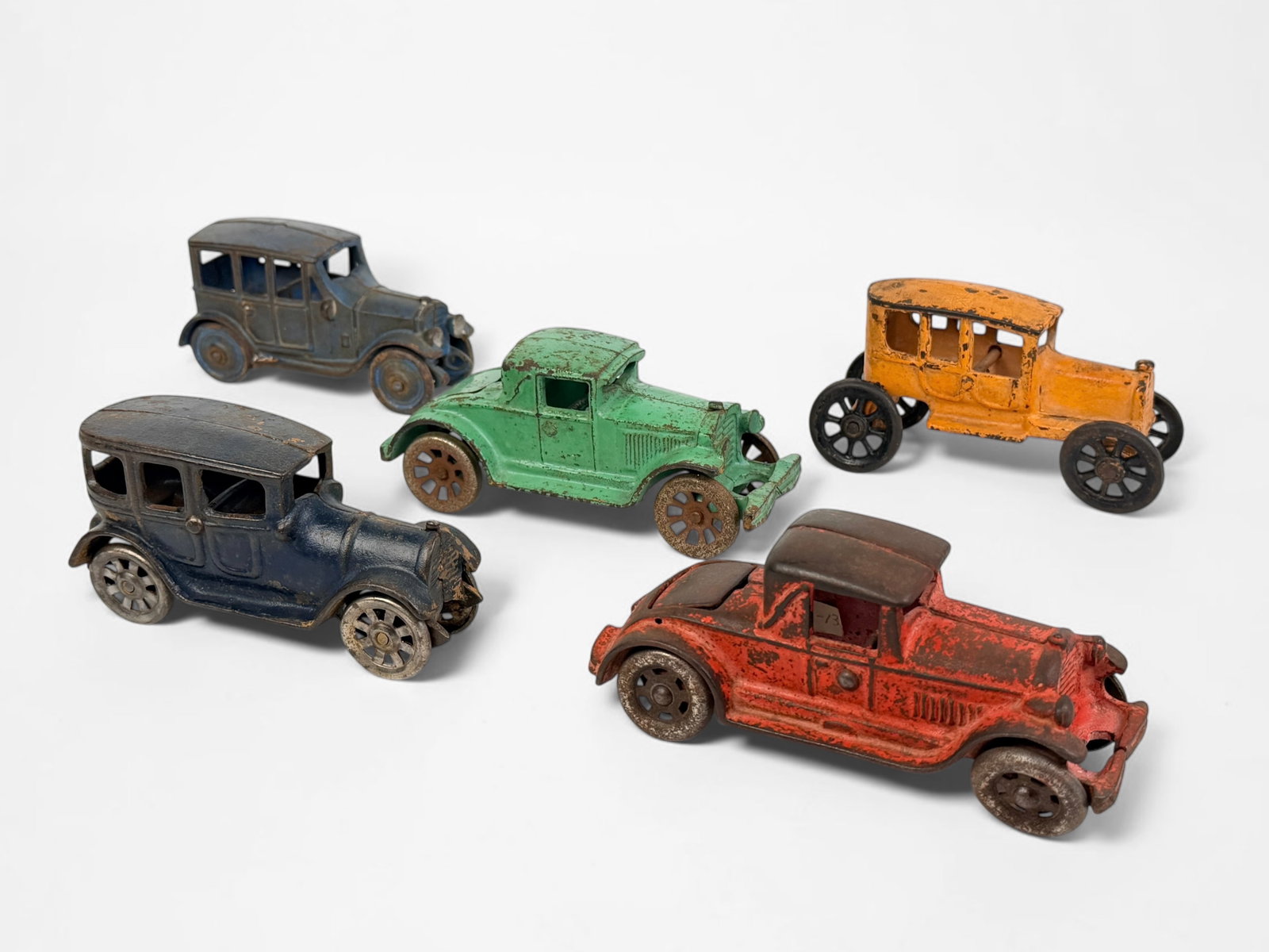 (5) Antique Cast Iron Toy Cars (B): Includes brands such as Arcade Manufacturing Co and AC Williams. Dimensions of Largest: 2 3/4" x 5" x 2" Condition: Rust throughout all of the cars, some sets 