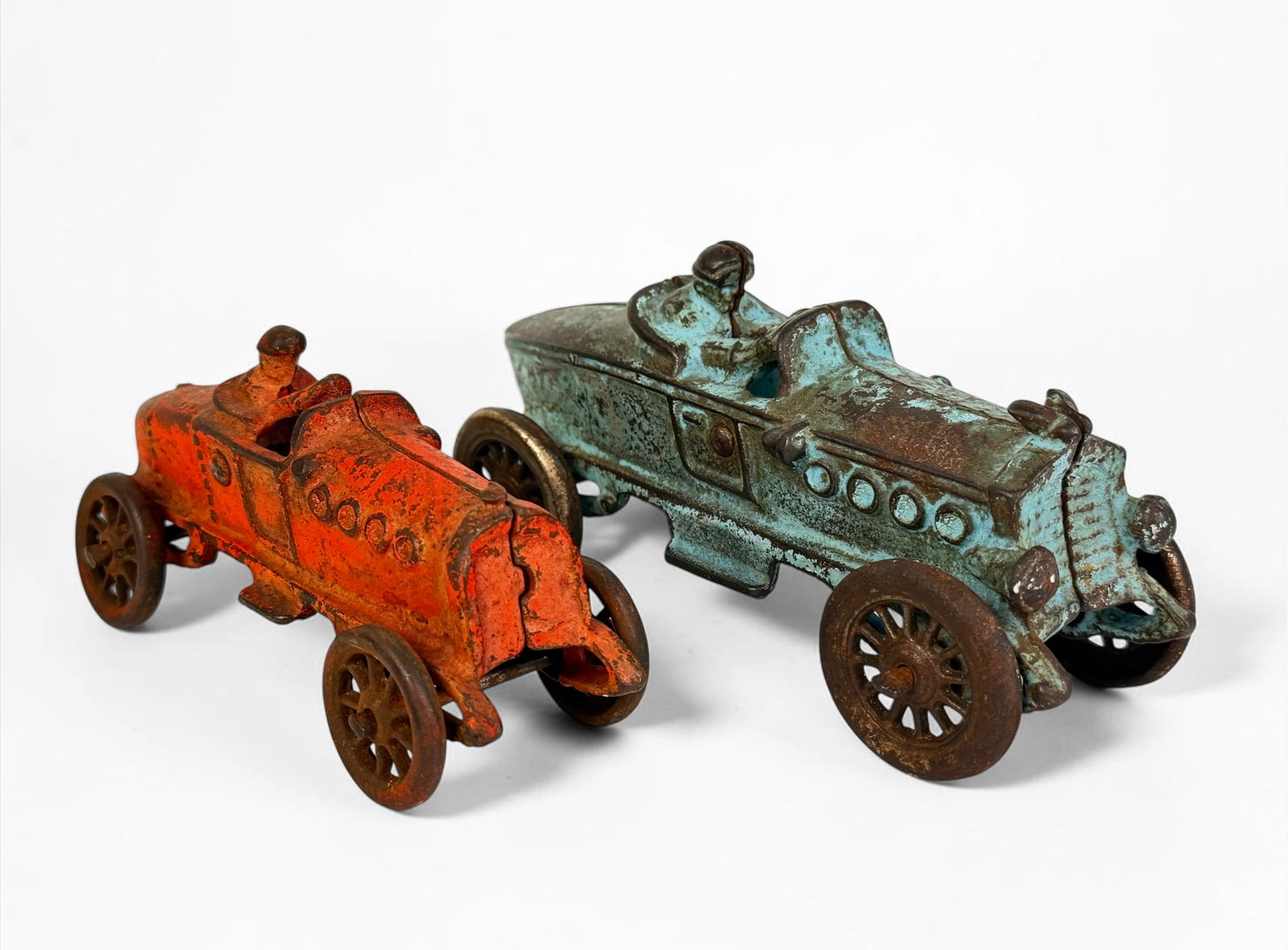 (2) Antique Cast Iron Racing Toy Cars (C): Includes brands A.C. Williams and Hubley. Dimensions of Largest: 2 1/2" x 6 1/2" x 2 1/4" Condition: Rust throughout the cars, loss of blue pigment to the larger car