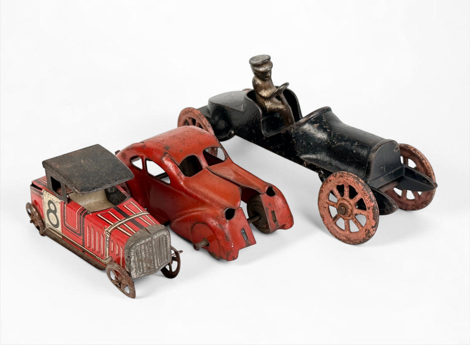 (3) Antique Cast Iron & Tin Toy Cars (H): The lot includes one cast iron toy car and two tin toy cars. Includes brands such as Marx, Hubley, etc. Dimensions of Largest: 4" x 7 1/2" x 2 1/2" Condition: 