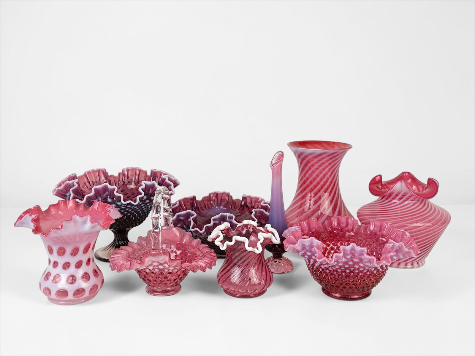 (9pcs) Pink Fenton Glassware: Largest Piece: 9" Tall x 6" Diameter Smallest Piece: 4 1/2" Tall x 5" Wide Condition: The set is in good condition. Please see images for details. 
