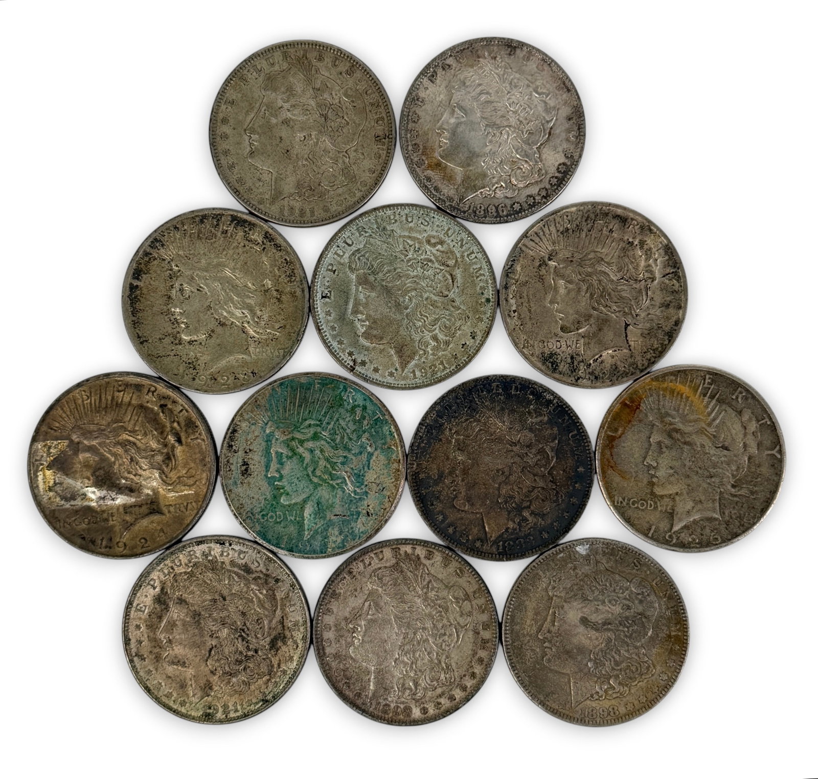 (12) Silver Dollars: Lot Includes the Following Dates: (3) 1923 (1) 1924 (1) 1926 (2) 1898 (3) 1921 (1) 1896 (1) 1883 Condition: Tarnishing and oxidation throughout. See images for details. 