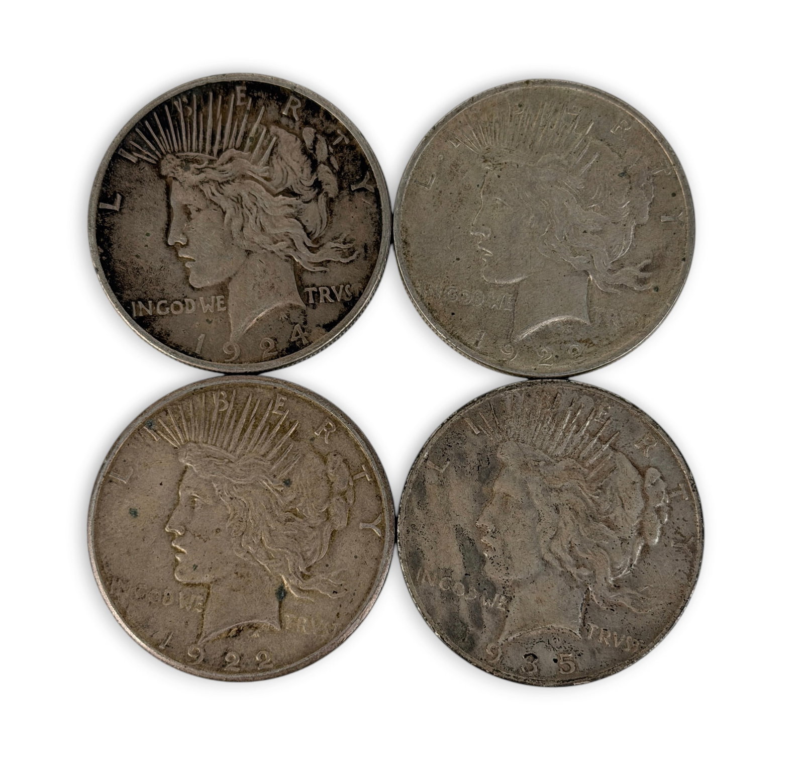 (4) Silver Peace Dollars: The coins have various dates. Condition: Various levels of tarnishing throughout the coins. Please see images for details. 