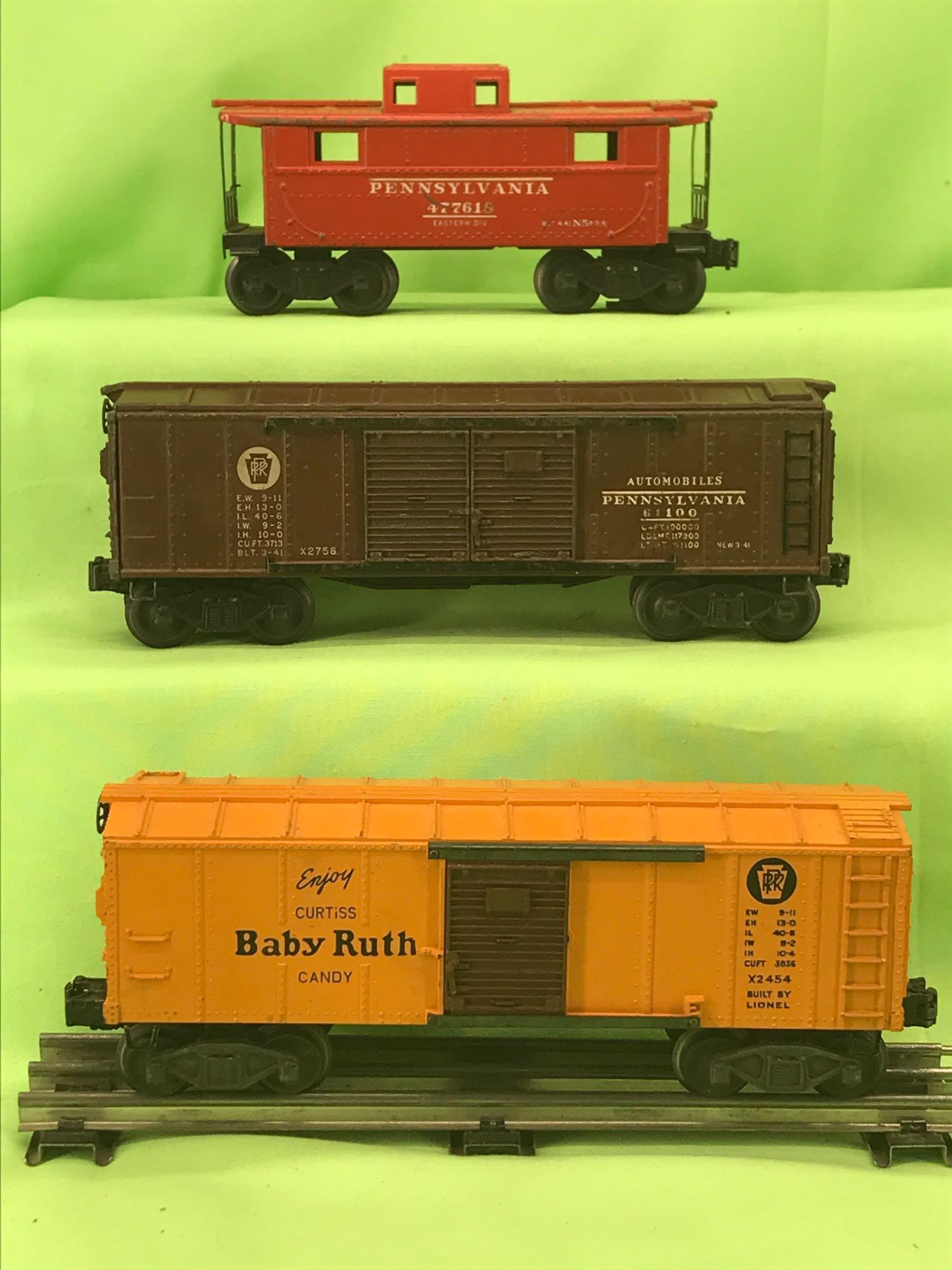 Lionel O gauge 2454 Baby Ruth 2758 PRR Automobiles 2457: Postwar Lionel O gauge 2454 Pennsylvania Baby Ruth boxcar, 2758 Pennsylvania double door automobiles car, and 2457 Pennsylvania caboose. Trains are C6.