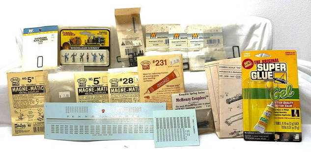 HO gauge couplers hand grabs diaphragms Engineer: HO gauge couplers hand grabs diaphragms Engineer figures passenger McHenry Couplers. Opened packages of Kadee couplers, Packages of Walthers diaphragms, Detail Associates diesel details EMD cab roof