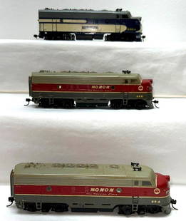 HO gauge custom decorated Monon and Wabash diesel A: Unmarked HO gauge custom decorated diesel locomotives; two Monon A units, one is powered, one is dummy; Wabash powered unit. One Monon is missing a windshield. Trains should clean C6 area.