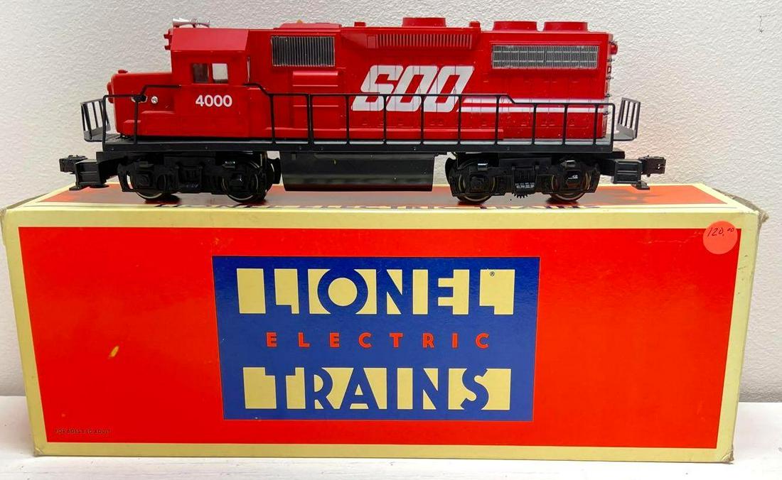 Modern era Lionel O gauge 18825 SOO Line GP38-2 diesel: Modern era Lionel O gauge 18825 SOO Line GP38-2 diesel in original box. One coupler has glue and missing release button/tab. Missing trim, glue repairs. Switch mounted in nose of cab. Box show a littl