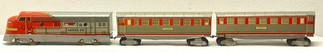 Western Germany Santa Fe TD1234 diesel locomotive with two passenger cars: Western Germany Santa Fe TD1234 diesel locomotive with two passenger cars, tin plate lithographed. One passenger car is missing a wheels set.