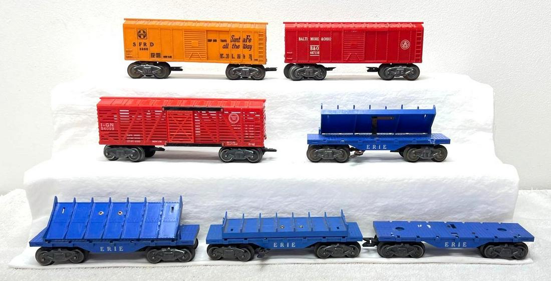 Postwar Marx O Gauge 05594 x4 3280 467110 54099: Postwar Marx O Gauge four 05594 Erie side dumping log cars, 3280 SFRD Santa Fe boxcar, 467110 Baltimmore and Ohio boxcar, 54099 Missouri Pacific stockcar. One flatcar is missing carriage and mechanism
