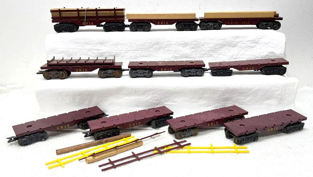 Postwar Marx O Gauge long and short Erie flat cars some stake sides some loads: Postwar Marx O Gauge long and short Erie flat cars (one is a manual side dump log car), some stake sides, some lumber/log loads. Some rust on some cars, some broken stake sides, etc. Please view the i