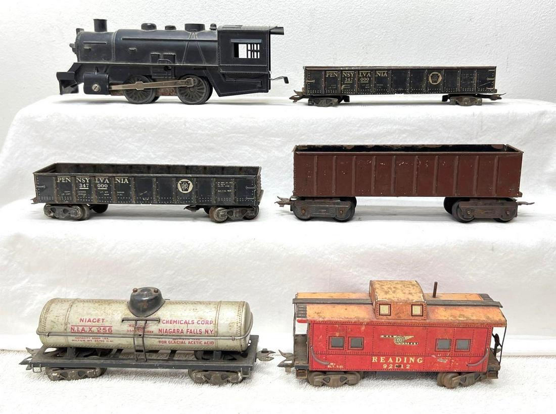 Postwar Marx O Gauge 0-4-0 key wind loco 3552 3552 256 92812: Postwar Marx O Gauge unnumbered plastic 0-4-0 key wind steam locomotive missing cab corner, two 3552 Pennsylvania gondola 347000, 256 Niacet Chemicals Corp single dome tank car, 92812 Reading caboose,