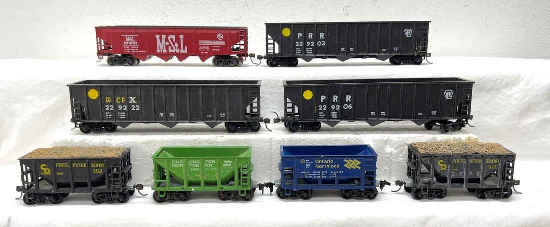 HO Gauge/Scale Rivarossi eight hoppers two with loads: HO Gauge/Scale eight hopper cars, one marked Rivarossi. Other freight is unmarked, two with loads, some missing or cracked steps/struts. Most cars have knuckle couplers, some metal wheels. Trains rang