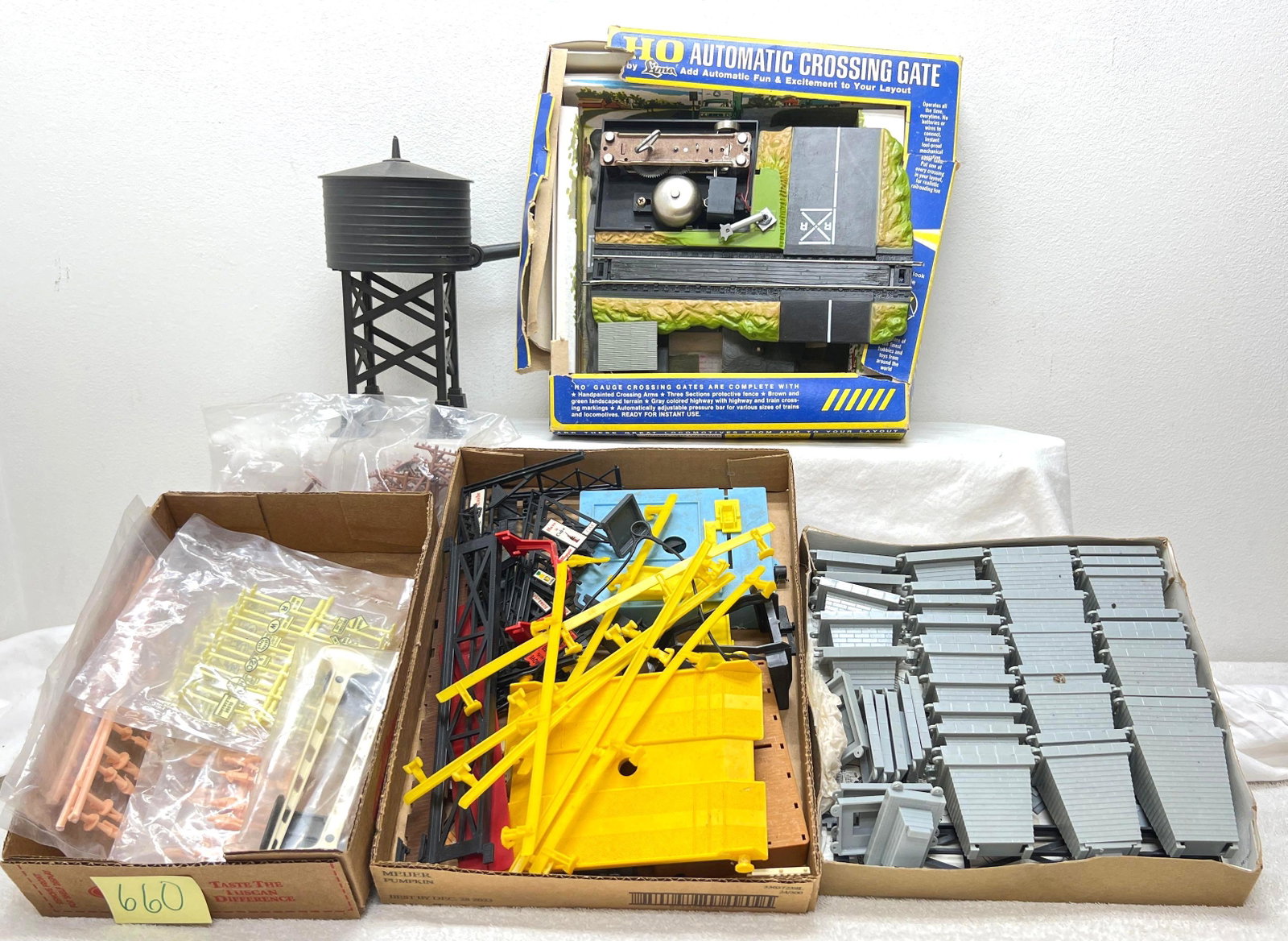 HO Gauge/Scale Lima crossing gate figures signs water tower more: HO Gauge/Scale Lima crossing gate in worn original package. Figures and railroad signs on sprues. Plastic water tower. Telephone poles, trestle set components and more. Please view the photos of the i