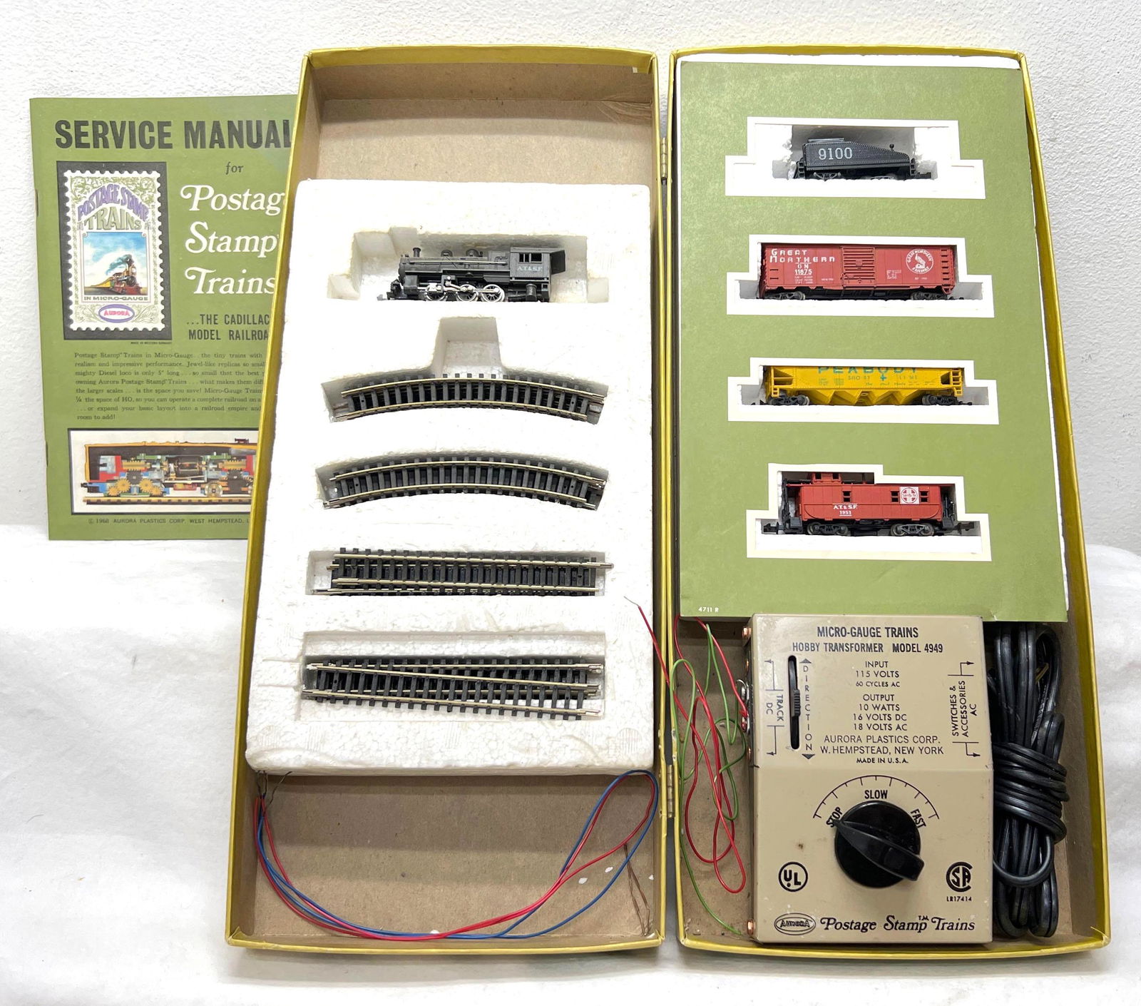 N Scale Aurora Postage Stamps Trains 4726 O-6-O Express Freighter set in OB: N Scale Aurora Postage Stamps Trains 4726 O-6-O Express Freighter set in original container missing styrofoam inserts for transformer. Trains are dusty but should clean to look C7. Box is dusty with g