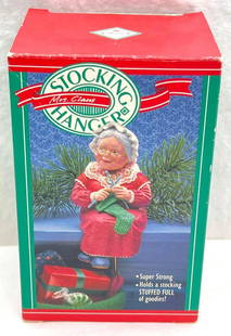 Hallmark Keepsake Ornaments 1988 Mrs Claus Stocking Hanger: Hallmark Keepsake Ornaments 1988 Mrs Claus Stocking Hanger. This is a cute stocking hanger from 1988 featuring Mrs. Claus knitting a stocking. Ornament is used but in excellent condition. Box is in