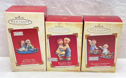 Hallmark Keepsake Ornaments Raggedy Ann and Andy lot of three Holiday Hug Holiday Sledding and more: Hallmark Keepsake Ornaments Raggedy Ann and Andy lot of three Holiday Hug Holiday Sledding and more. This great lot has three Raggedy Ann and Andy ornaments. This lot includes, 2003 A Gift For