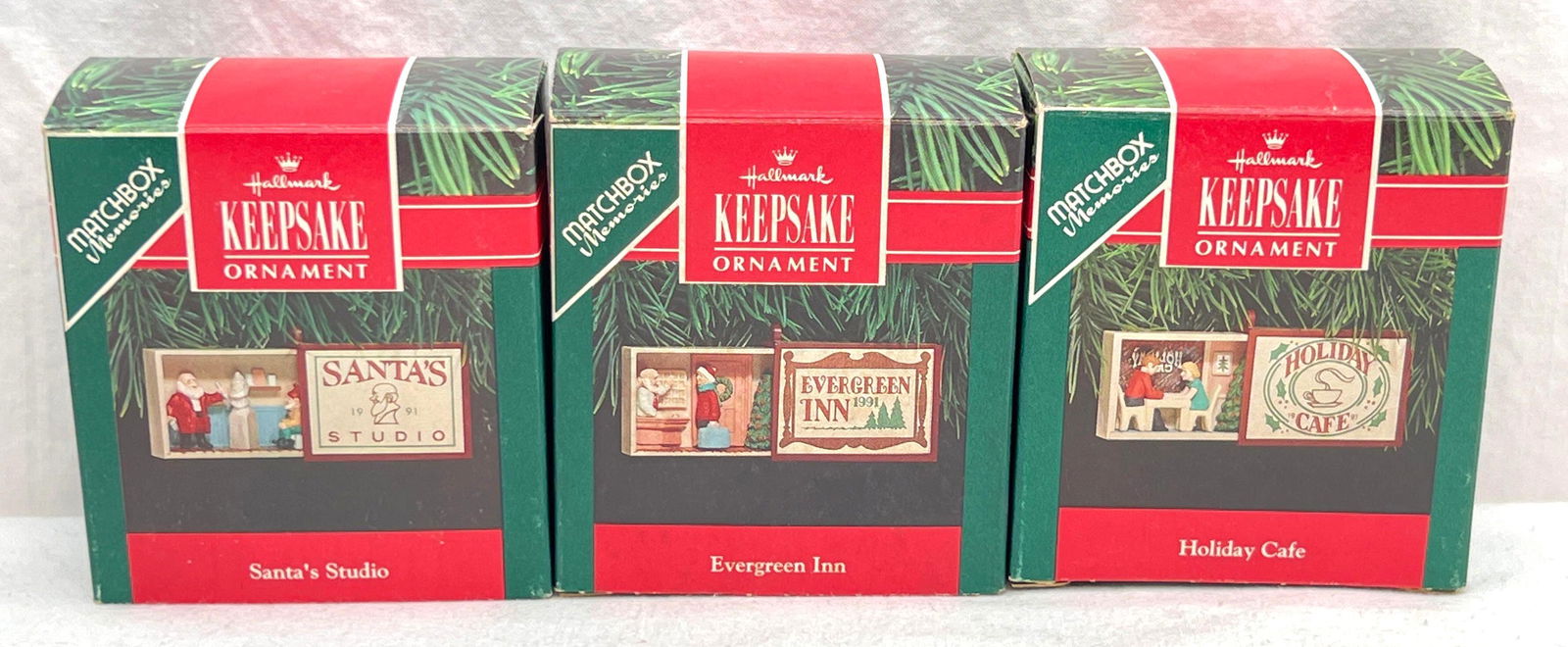 Hallmark Keepsake Ornaments lot of three Matchbox Memories: Hallmark Keepsake Ornaments lot of three Matchbox Memories. This great lot includes, 1991 Santa's Studio, 1991 Evergreen Inn, 1991 Holiday Caf�. All ornaments are in excellent condition. Bo