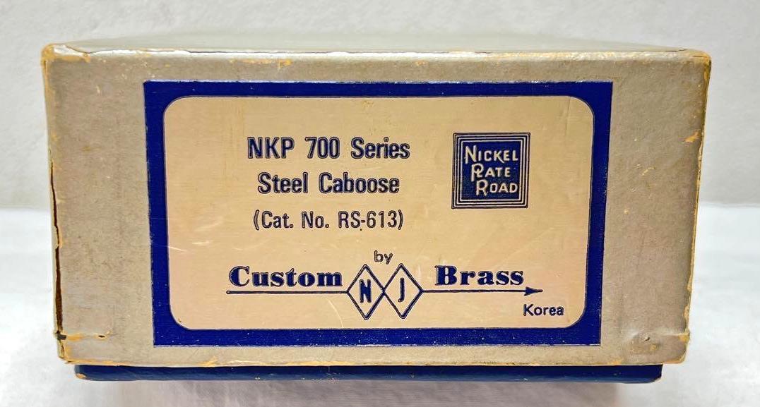 Custom Brass NJ HO scale RS-613 NKP 700 steel caboose in box: Custom Brass by NJ, HO scale RS-613 Nickel Plate Road NKP 700 Series steel caboose unpainted in original box. Unrun C9-10. Box has good foam, good label, light surface wear, very square and solid box.