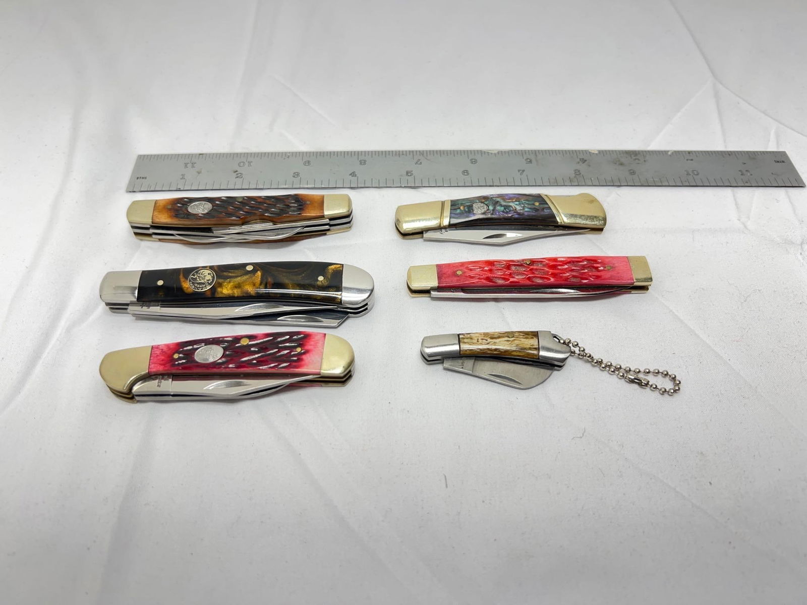 Frost Tomahawk Beaver Creek Steel Warrior folding: Frost Cutlery pen and folding hunter, Tomahawk micro keychain, Beaver Creek 2 blade trapper, Steel Warrior 2 blade and 4 blade folding knives. All knives have locking blades except the Tomahawk. All a