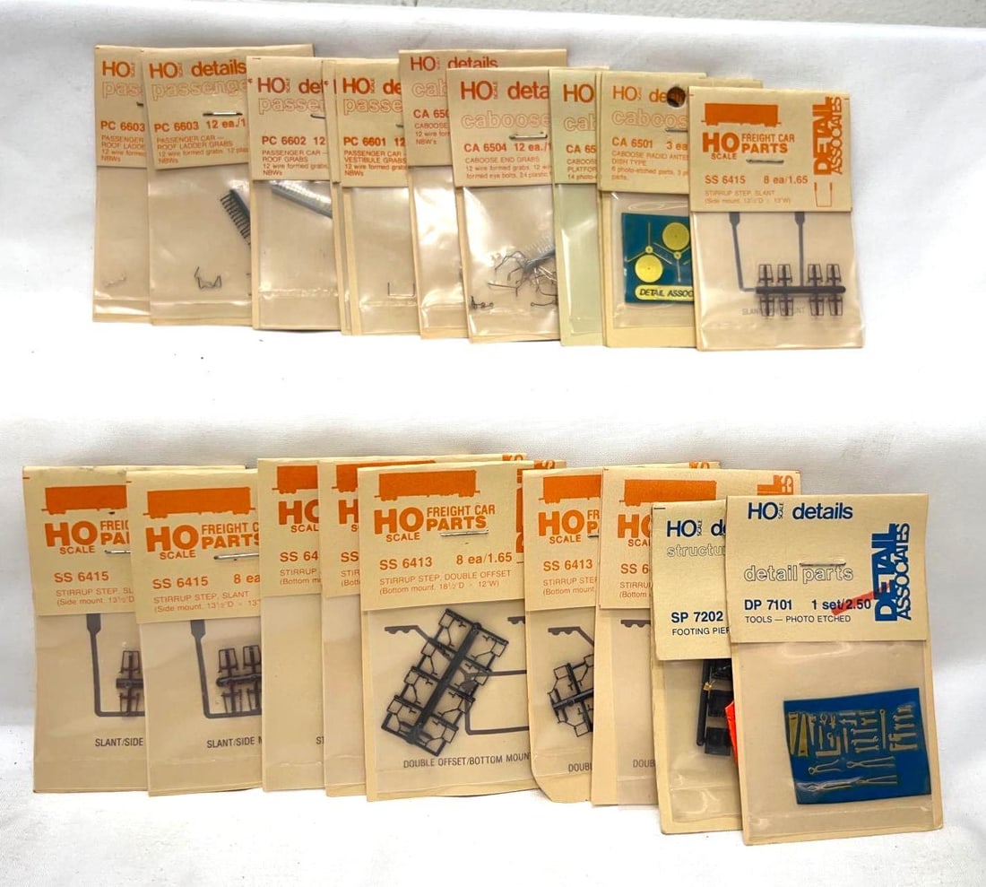 HO Scale Detail Associates trim and parts NIP: HO Scale Detail Associates DP7101 tools, SP7202 footing piers, three SS6413 stirrup steps, two SS6414 stirrup steps, three SS6415 stirrup steps, two CA6501 caboose radio antenna dish type, CA6502 cabo