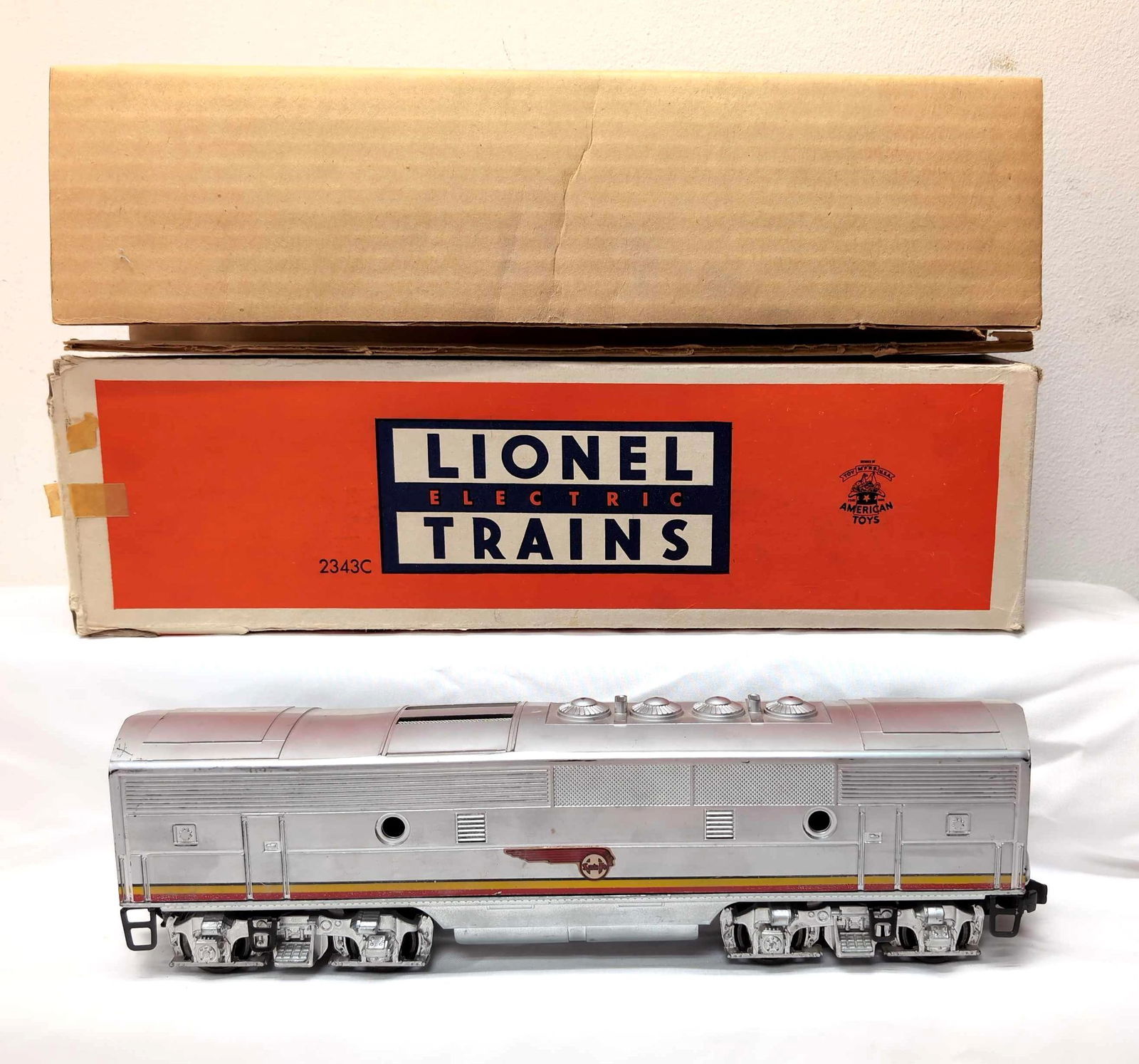 Postwar Lionel O Gauge 2343C Santa Fe B in box: Postwar Lionel O Gauge 2343C Santa Fe F3 diesel B unit in box, C6++. Excellent stripes, perfect decals, bright and shiny, screened roof vents. Box has tape repaired flaps, no missing flaps, so