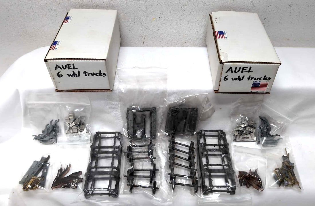 Two AUEL 6 whl trucks NIB unassembled: Two 2-Rail O Scale AUEL 6 wheel trucks, NIB New In Box, unassembled. Please view the photos of the items in this lot carefully as they are being sold as they are shown in our photos with NO returns or