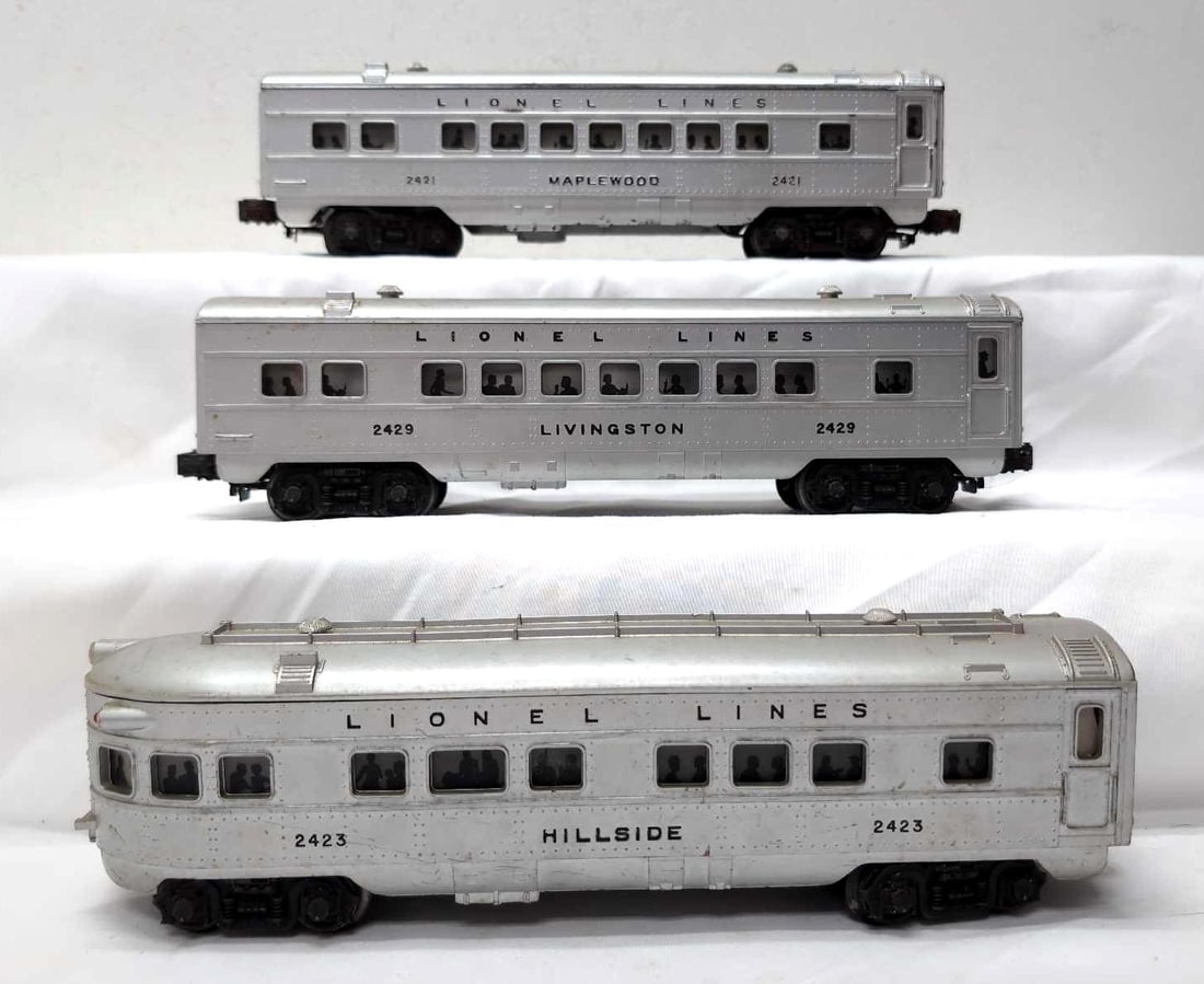Postwar Lionel O Gauge 2421 2429 2423 passenger cars: Postwar Lionel O Gauge 2421 Maplewood coach, 2429 Livingston coach, 2423 Hillside observation, passenger cars. 2421 is repainted and re-lettered. Trains otherwise look C6. Please view the photos of th
