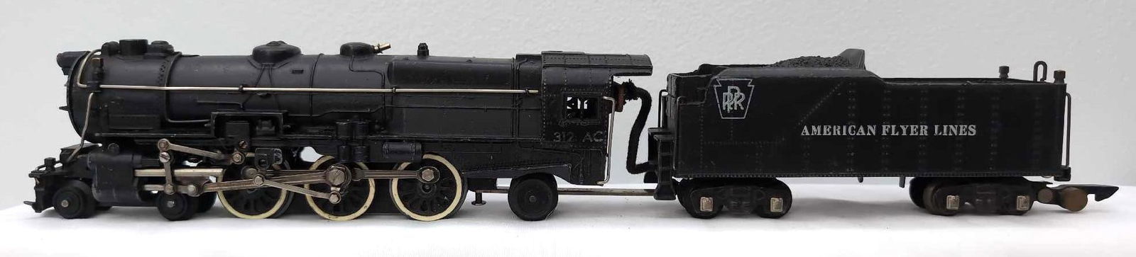 Postwar American Flyer S Gauge 312AC 4-6-2 PRR Pacific steam: Postwar American Flyer S Gauge 312AC 4-6-2 Pennsylvania PRR Pacific die-cast steam locomotive, missing a pilot step, otherwise C7. Marker jewels included.