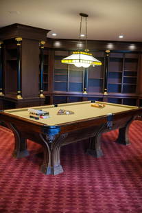 Brunswick Pool Table with leather pockets: Brunswick Pool Table with leather pockets, inlay on legs, tan felt, balls, rack, que sticks and a set of set of (16) Villa Collina balls, scoring equipment, stain glass twin globe light fixture