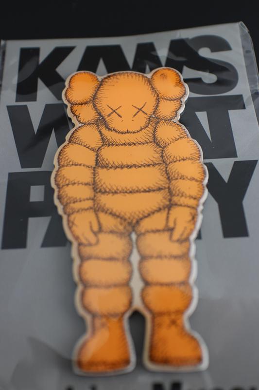 KAWS (American, b.1974) "What Party?" orange magnet, brand new, 4 x 2 in. (1 of 2)