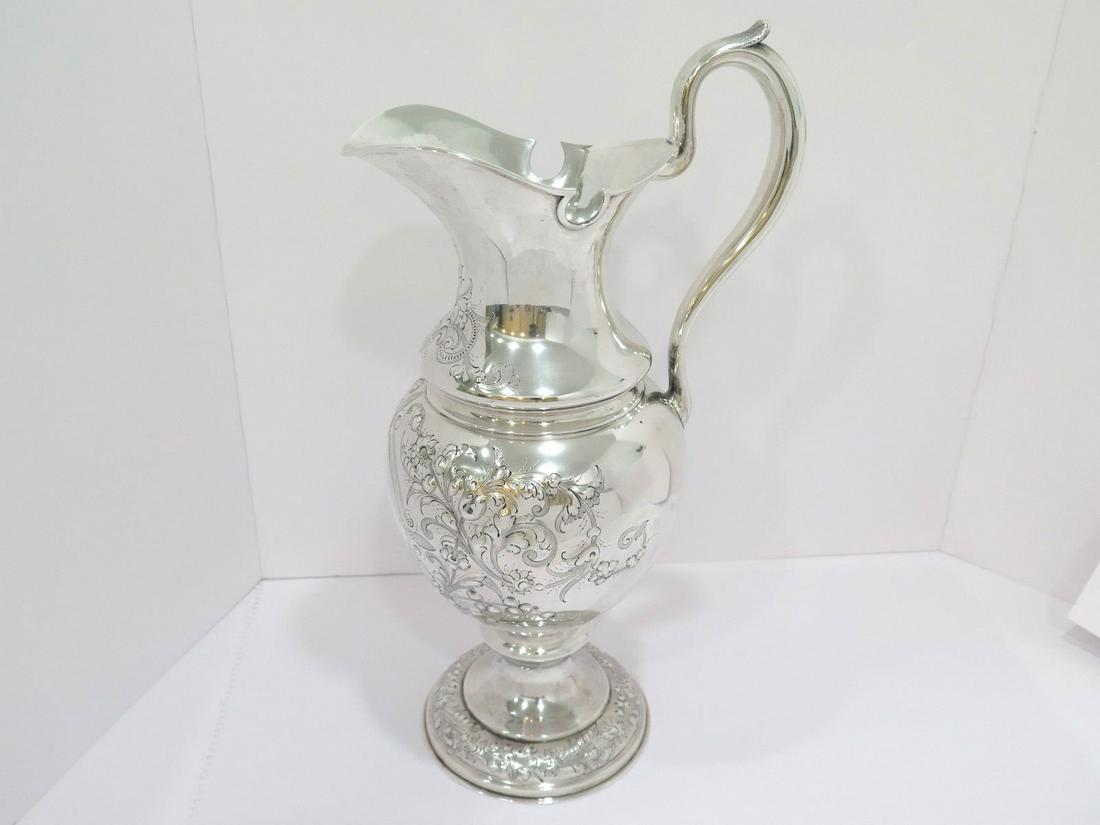 18 3/8 in - Sterling Silver Duhme & Co. Antique Floral Repousse Pitcher: Dimensions (h x l x d): 18 3/8 x 10 x 7 3/8 in; Weight: 47.2 toz