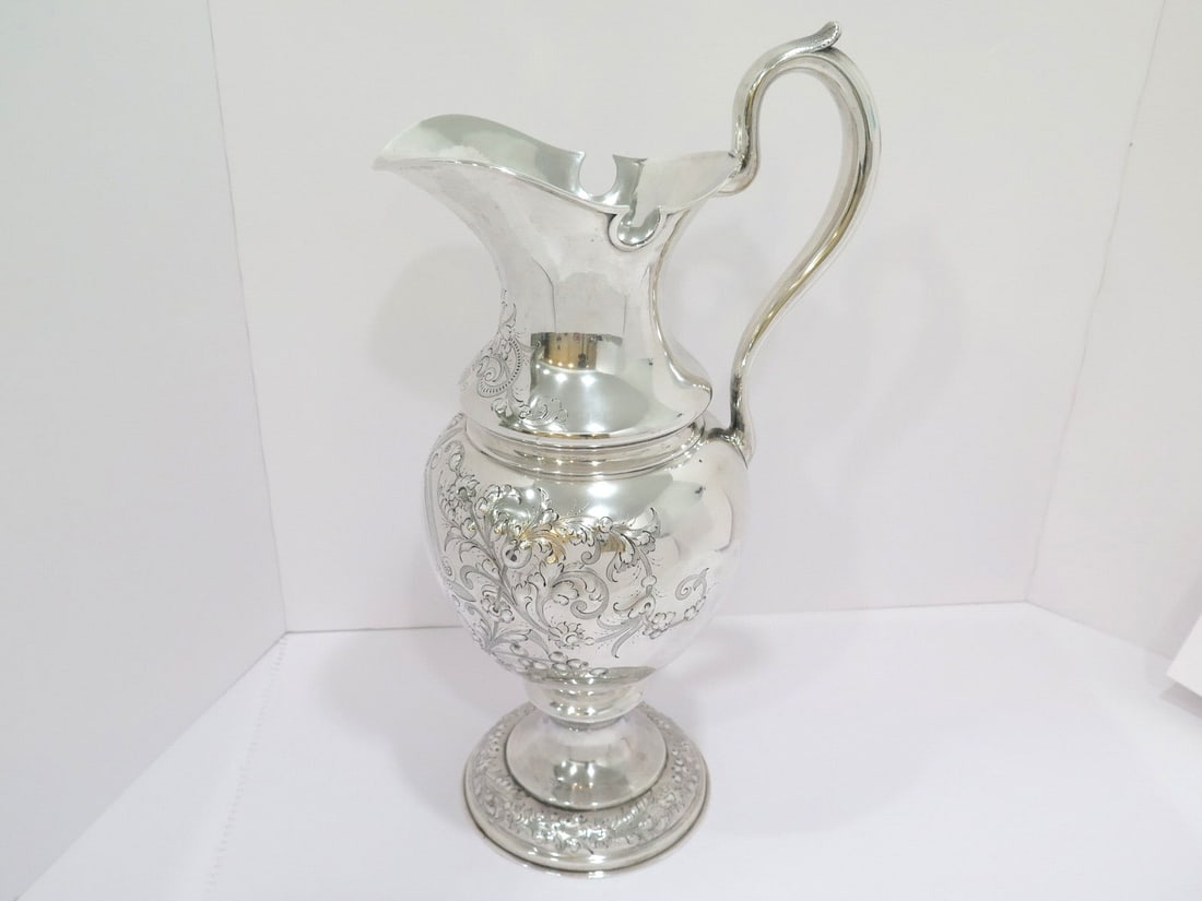 18 3/8 in - Sterling Silver Duhme & Co. Antique Floral Repousse Pitcher: Dimensions (h x l x d): 18 3/8 x 10 x 7 3/8 in Weight: 47.2 toz