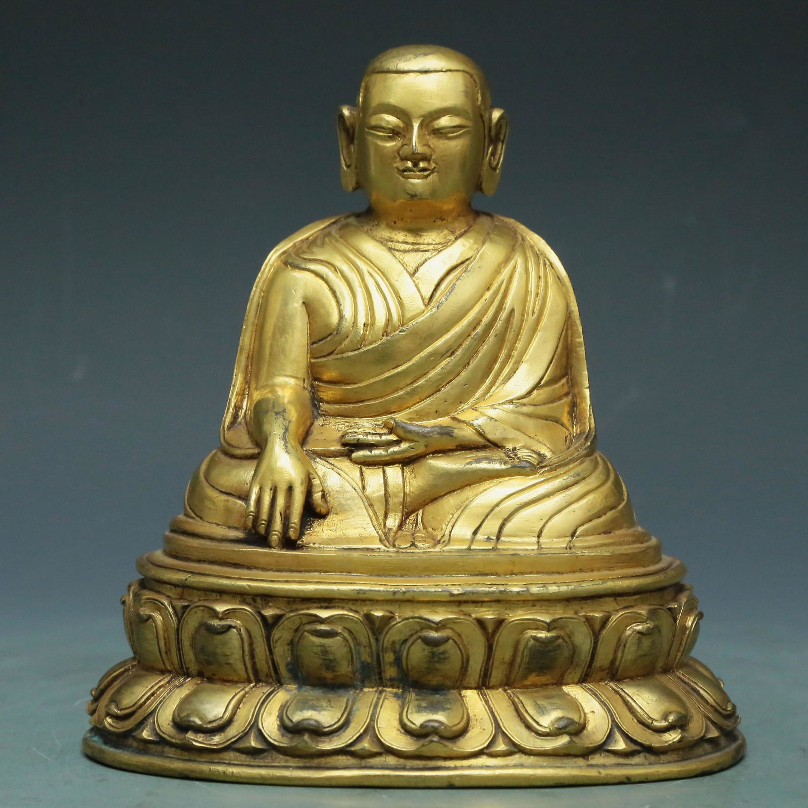 A Magnificent Gilt-Bronze Figure Of Brog.Mi: A Magnificent Gilt-Bronze Figure Of Brog.Mi. The figure with a dignified expression is rendered clad in long, flowing robes, the voluminous drapery elegantly cascading in folds. 15th Century. Size:12.