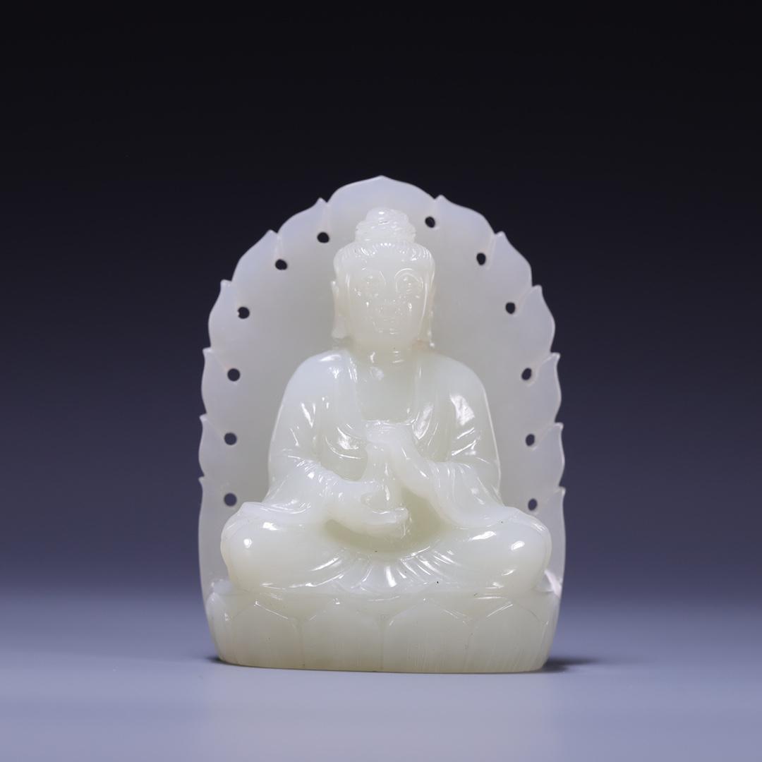 A Superb Hetian Jade Figure Of Guanyin: A Superb Hetian Jade Figure Of Guanyin. The figure is seated, hair tied into a high chignon, body rendered clad in a long robe, the voluminous drapery elegantly cascading in folds, behind back a holy,