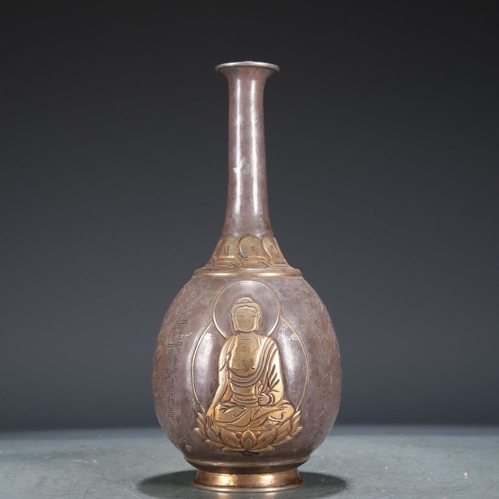 A Wonderful Gilt-Silver 'Buddha Shakyamuni' Vase With Inscriptions: A Wonderful Gilt-Silver 'Buddha Shakyamuni' Vase With Inscriptions. Cast with a figure, body rendered clad in a long robe, the voluminous drapery elegantly cascading in folds, vase with a tall, slende