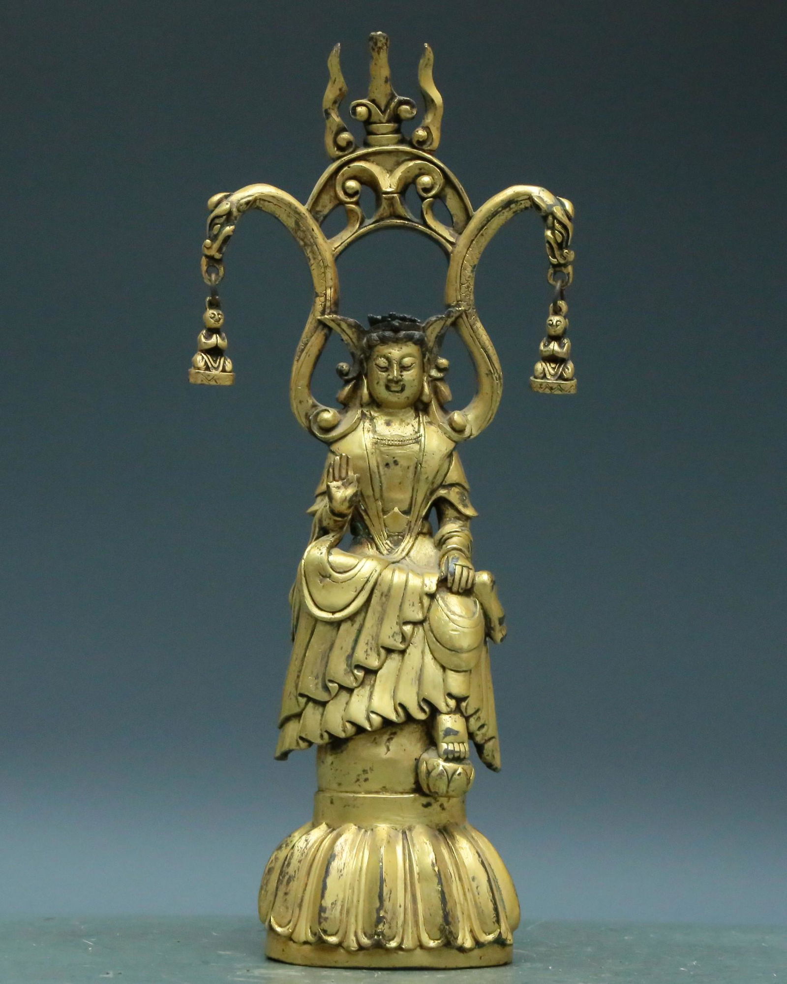 A Superb Gilt-Bronze Figure Of Guanyin: A Superb Gilt-Bronze Figure Of Guanyin. The figure is seated, body rendered clad in a long, flowing robe, the voluminous drapery elegantly cascading in folds. Chinese Northern Dyuasties Size:10cmx6cmx