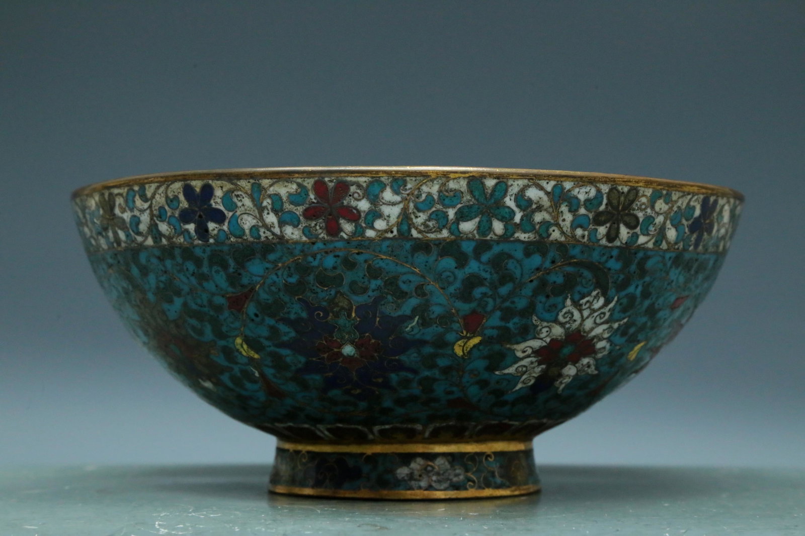 A Wonderful Cloisonne 'Scrolling Lotus' Bowl: A Wonderful Cloisonne 'Scrolling Lotus' Bowl. Enameled with polychrome patterns, all reserved on a bright turquoise ground. Chinese Ming Dynasty. Xuande Six-Character Mark. Size:22cmx9.5cm