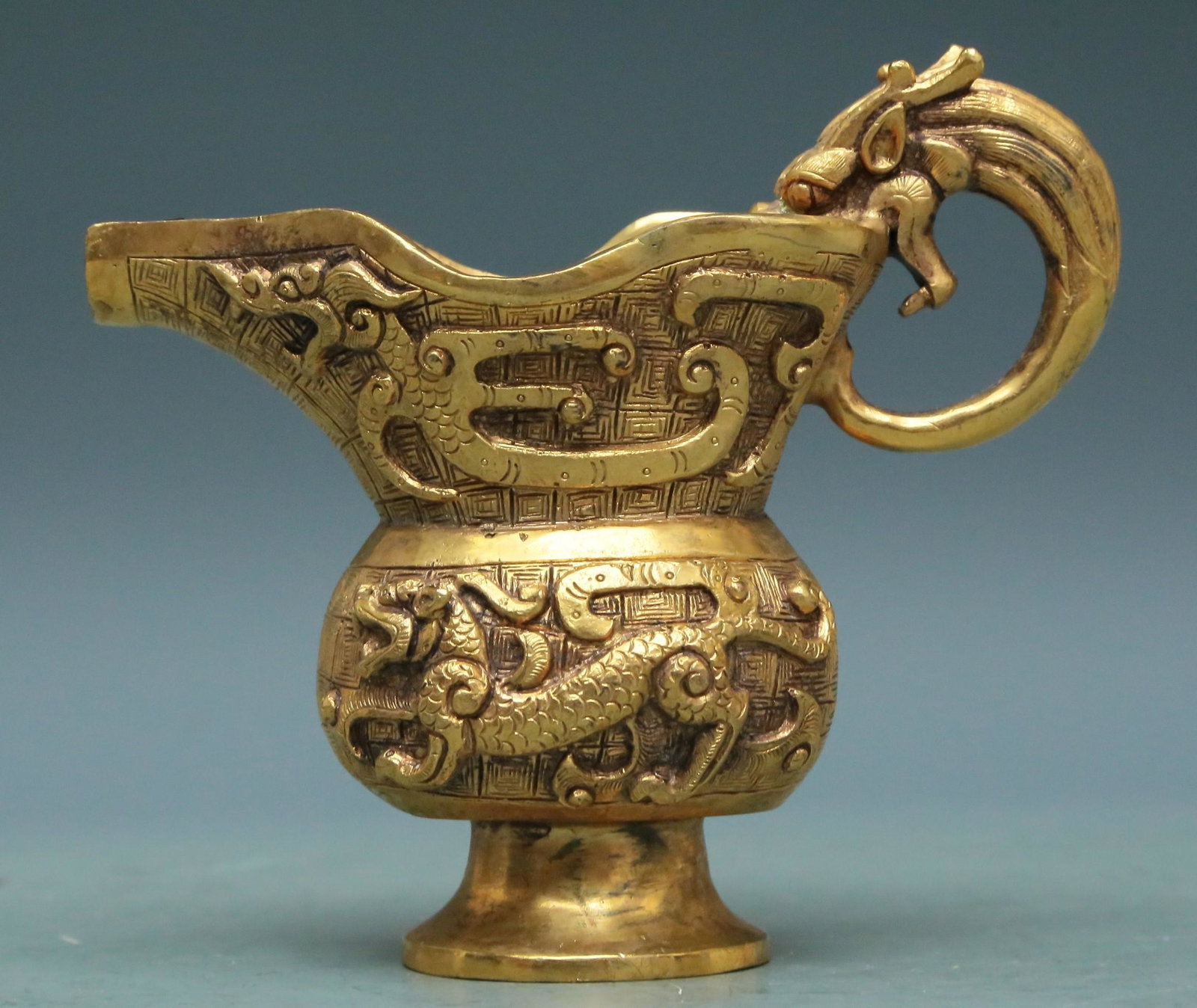 A Superb Gilt-Bronze 'Dragon' Ewer: A Superb Gilt-Bronze 'Dragon' Ewer. Cast in detail with angular scrolls and scaly dragons. Chinese Qing Dynasty. Size:12cmx5.5cmx11cm