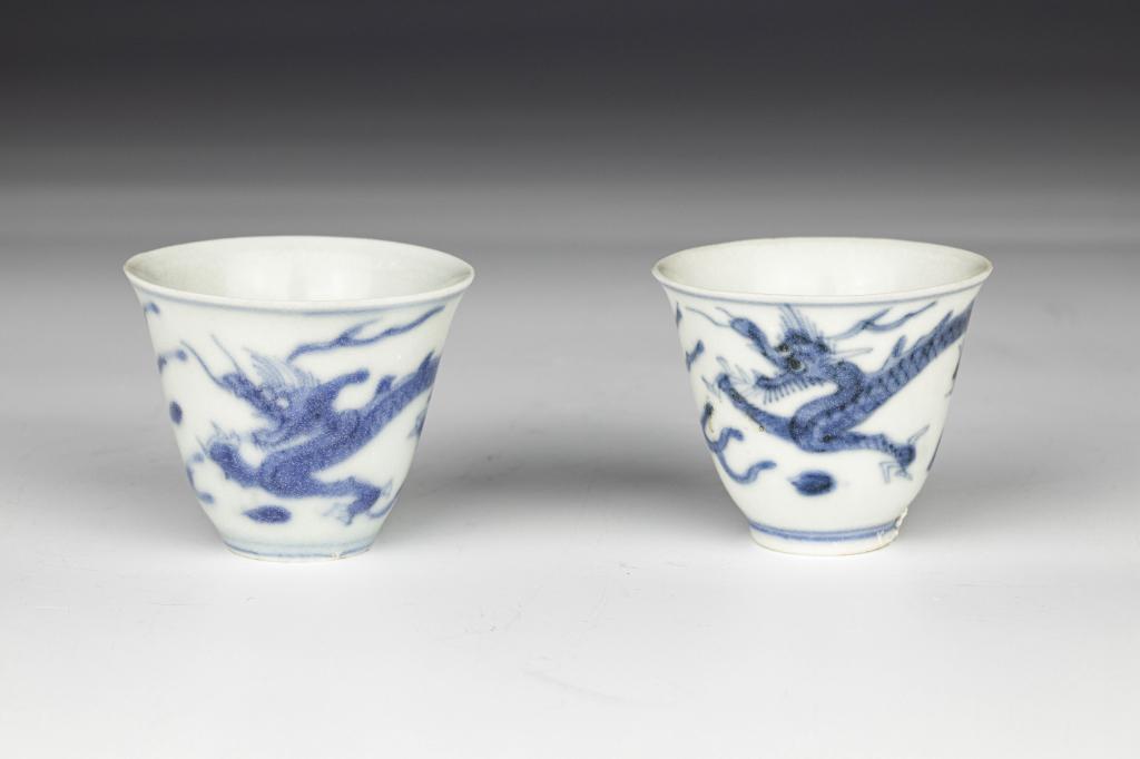 Pair Ming Wanli Blue White Dragon Wine Cups: China, Ming dynasty, Wanli period, 17th century Dimensions: 1 1/2"(4 cm) H, 7/8"(2.3 cm) Base dia A pair of Ming Wanli blue-and-white dragon wine cups, with depiction of a flying dragon and cloud patt