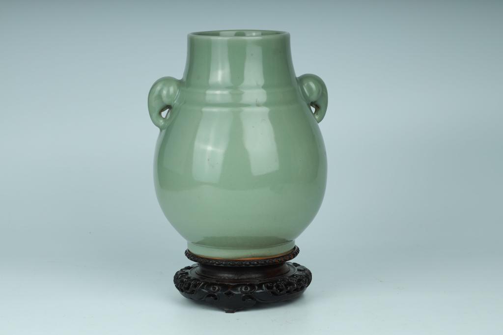 Longquan Celadon-Glazed Zun-Type Handled Vase with Stand, 20th Century or Earlier: China, 20th century or earlier Dimensions: 9.3" (23.5cm) H Longquan celadon-glazed zun-shaped baluster jar with two handles imitating elephant ears. 20世紀或更早 龍