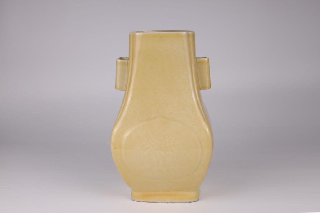 Yellow-Glazed Hu-Shaped Floral Twin-Handled Vase, Early 20th Century: China, early 20th century Dimensions: 12" (30.5cm) H The pear-shaped octagonal vessel of archaic hu form, with a round belly rising up from a straight foot to a tapered neck slightly flaring at the ri