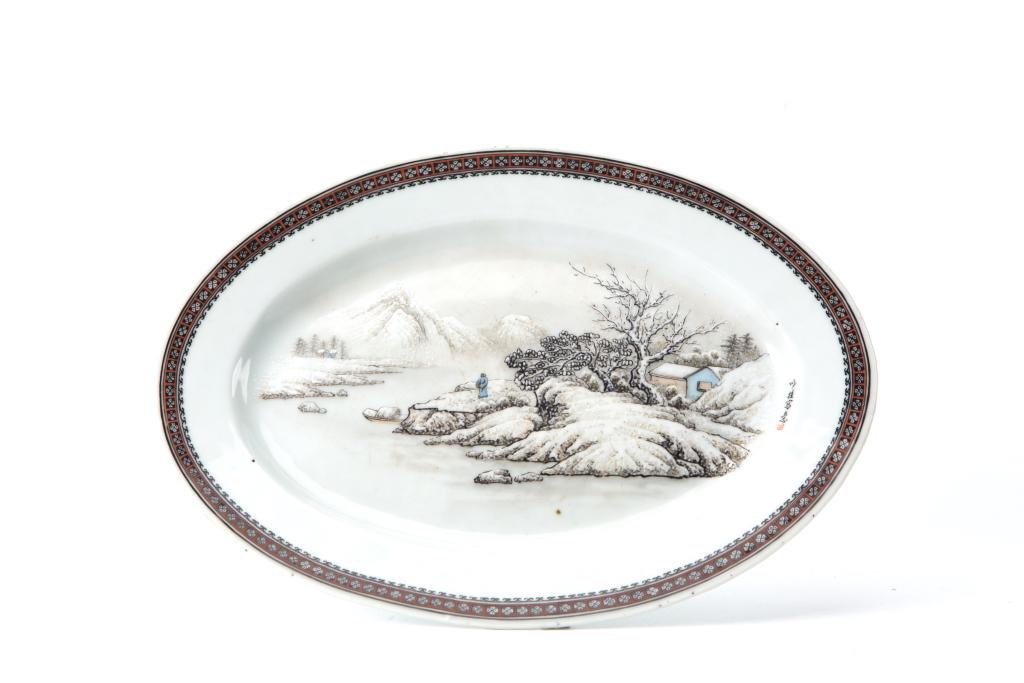 Famille Rose Snowy Landscape Dish, Jingdezhen Mark: China Dimensions: 10.6'' (26.8cm)L, 7.5'' (19cm)W, 0.9'' (2.3cm)H Famille rose dish decorated with painted landscape in snow to the interior with a tile of floral motif to the rim. Four-character Jing