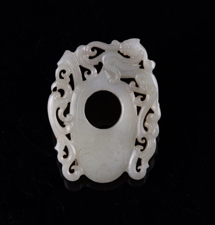Jade Carved Openwork Dragon Plaque: China Dimensions: 2 1/2" (6.4cm) L Jade carved plaque with openwork dragon decoration around the central ring. 螭龙雕玉牌